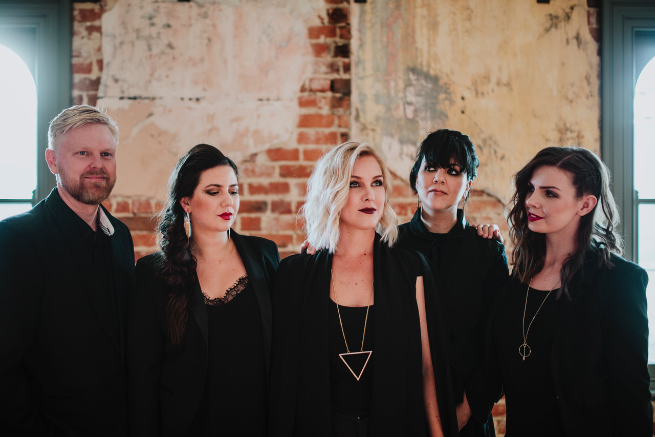 The Aquila ensemble, editorial portrait against a brick wall