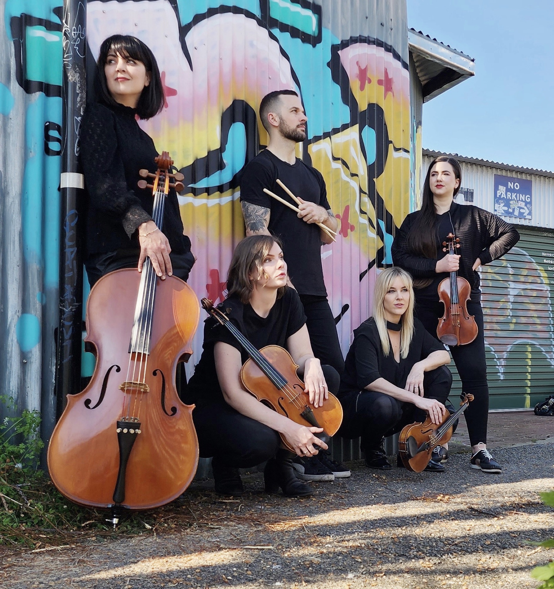 The Aquila string quartet band against a graffiti wall - shown in full